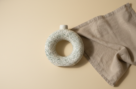 Minimal ceramic vase styled in a warm, cozy home interior